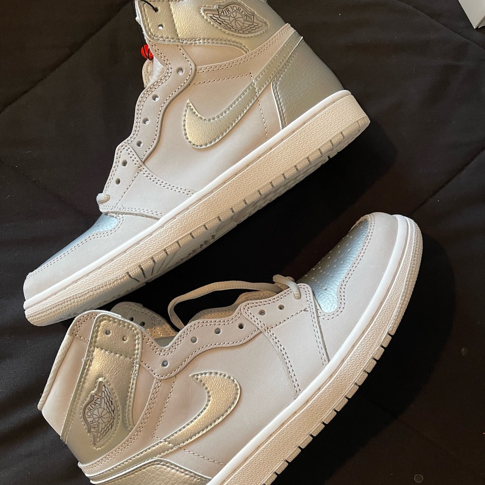 Nike Air Jordan 1s in neutral grey and silver